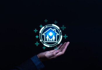 Health insurance and family protection concept with a businessman hand holding digital house icon and medical cross. Symbol of safety, healthcare, and medical security for family in modern technology.
