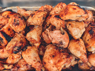 A lot of fried chicken with a lot of seasoning. The chicken is golden brown and crispy.