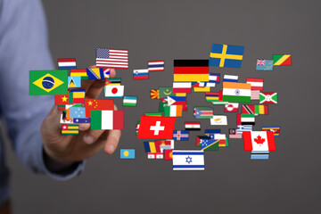 A hand reaching towards flags of different nations, symbolizing global connections, international...