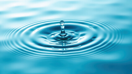 Water droplet creates ripples in serene blue surface, showcasing beauty of nature simplicity and tranquility