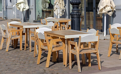 Wooden Chairs and Tables in Front of Italian Coffee Shop Craiova Romania Sunny Spring Day