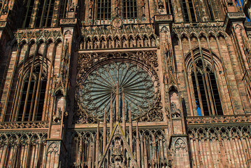 The majestic sandstone facade of the Strasbourg Cathedral, a masterful example of Gothic architecture. The immense central rose window, a stunning marvel of medieval artistry.