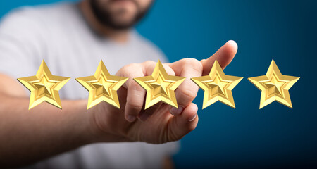 A person's hand reaching towards golden stars to represent a rating or review, symbolizing customer...