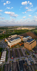 Obraz premium Colruyt, Wilgenveld, Halle, Vlaams Brabant, Belgium, 13th of May, 2025, A stunning aerial view of a modern hospital amidst vibrant green landscapes and beautiful open skies