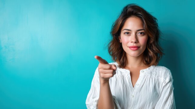 The image features a confident woman pointing toward the viewer, exuding a feeling of positivity and engagement, set against a vibrant teal background.