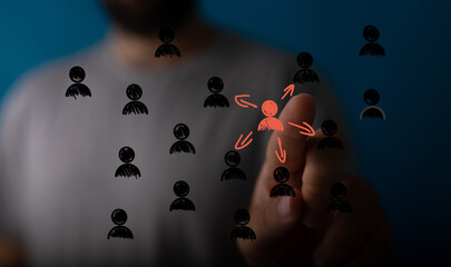 Image of a hand selecting a person icon, symbolizing leadership, team, choice, and strategy.