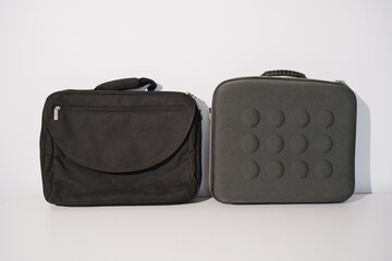 Different styles of black laptop bags on a simple background