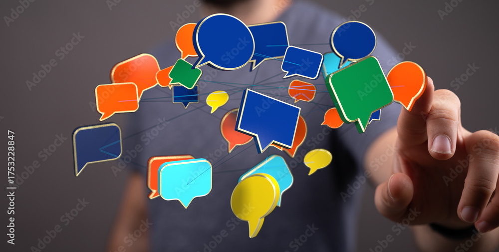 Wall mural man touching digital speech bubble icons demonstrating communication concept. connection with messag