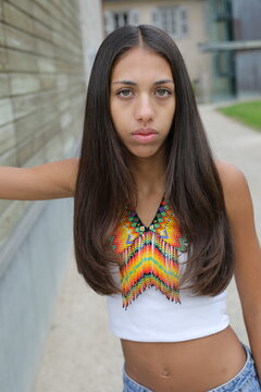 Serious young ethnic woman wearing beaded collar