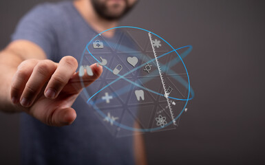 High-quality image depicting a man interacting with a futuristic digital interface showcasing various medical icons. Perfect for healthcar