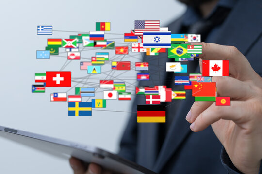 Person touching digital tablet with world flags. Concept of international relations, communication, business, and travel. Symbolizes global conn