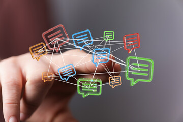 Abstract illustration of a hand connecting with a network of message bubbles, representing digital communication, social media, and online conne