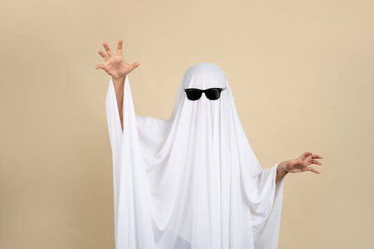Child dressed up in white costume of scary ghost for Halloween