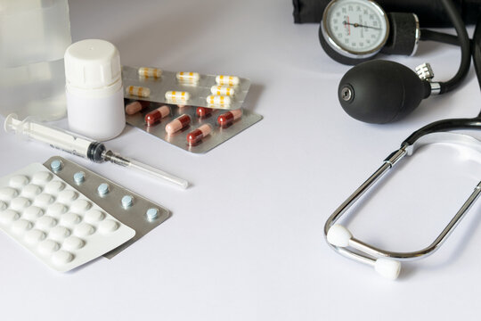 Stethoscope with pills, tablets and medical supplies on white background, healthcare and diagnosis concept representing medicine, pharmacy, prevention and hospital care