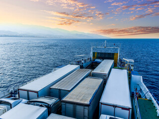 naval transport cargo ferry ship transporting wagon trucks to a destination port to supply trade goods to commercial sea port throuth sea and ocean