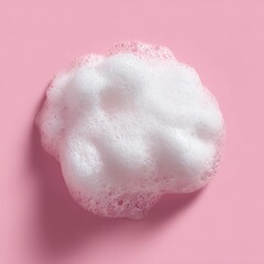 Fototapeta premium Minimalist shot of fluffy white soap foam cloud on pink background showcases cleanliness skincare and beauty concepts