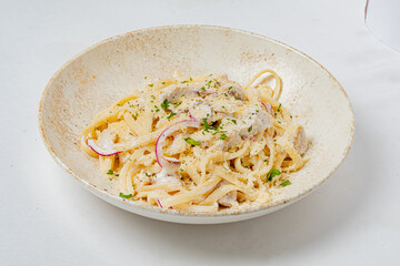 Delicious fettuccine topped with herbs, cheese, and pepper, showcasing a comforting meal
