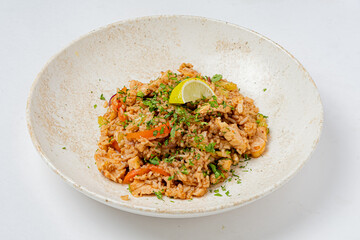 Rice cooked with colorful vegetables garnished with fresh herbs and a hint of lime zest