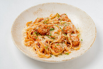 Spaghetti with meatballs, cheese, and fresh herbs creates a delicious dish