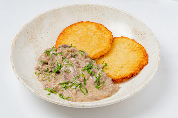 Savor the rich meat sauce paired with golden-brown potato patties, topped with fresh herbs