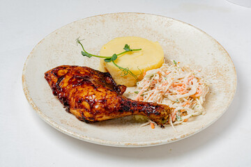 Savor juicy grilled chicken leg with tangy glaze, creamy mashed potatoes, and coleslaw!