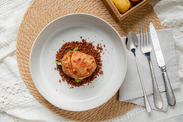 A lovely plate shows soft bread on crispy crumbs, accented by a touch of green garnish