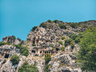Rock-cut tombs of the ancient Lycian necropolis. Myra is an antique town in Lycia where the small town of Kale (Demre) Turkey. Close-up of rock cut tomb grave.