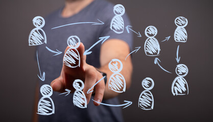 Man's hand interacts with a digital network of abstract people icons, symbolizing business connection, communication, social media, and teamwork