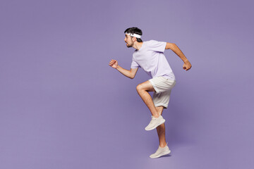 Full body side profile view young strong fitness trainer instructor sporty man sportsman wear sportswear train in home gym run fast isolated on plain purple background. Workout sport fit abs concept.