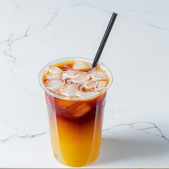 A tall cup filled with an iced drink showcasing vibrant colors and ice cubes