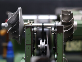 Turbocharger rotor assembly, featuring both the compressor and turbine wheels on a central shaft,...
