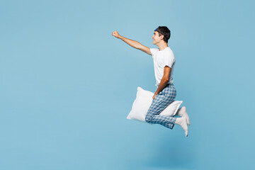 Full body calm young man he wear pyjamas jam sleep eye mask rest relax at home jump high hold...