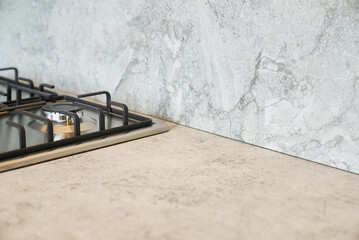 Modern kitchen countertop with gas stove and marble backsplash design