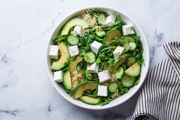 Green quinoa salad with cucumber, avocado and feta.