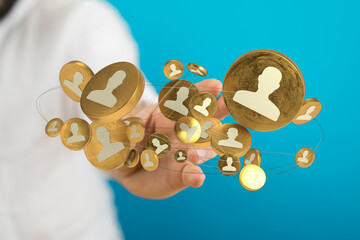Conceptual shot depicting hand interacting with gold coin icons symbolizing social networking and...