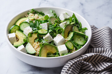 Green quinoa salad with cucumber, avocado and feta.