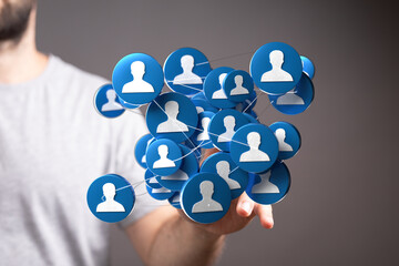 Man shows networked human icons, symbolizes social connections, teamwork, digital communication, relationships, and collaborative synergy.