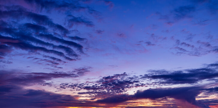 Colorful clouds and sky in the morning,Real majestic sunrise sundown sky background with gentle colorful clouds without birds. Panoramic, big size.