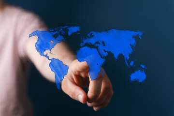 Image of hand interacting with a world map, representing global connections, networking, and international business.
