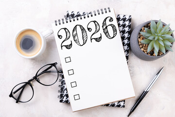 New year goals 2026 on desk. 2026 resolutions list with notebook, plant on table. Resolutions, plan, goals, action, checklist, idea concept. New Year 2026 resolutions, copy space