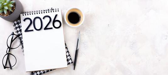 New year resolutions 2026 on desk. 2026 goals list with notebook, plant on colorful background. Resolutions, plan, goals, action, checklist, idea concept. New Year 2026 resolutions, copy space