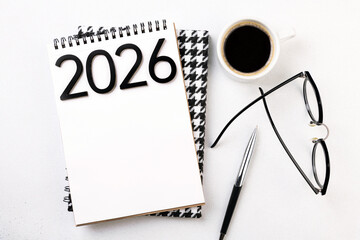New year goals 2026 on desk. 2026 resolutions list with notebook, plant on table. Resolutions, plan, goals, action, checklist, idea concept. New Year 2026 resolutions, copy space