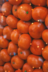 Fresh oranges create vibrant citrus background with festive glow