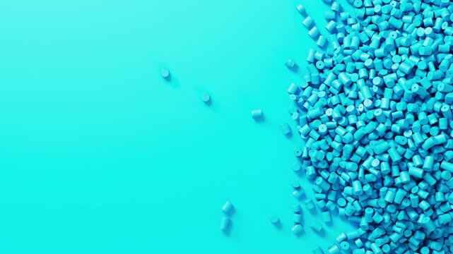 Closeup top view on cyan plastic polypropylene granules heap rotating on cyan backdrop, masterbatch polymer grain pile. HDPE or PVC resin pellets.