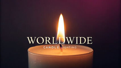 A single lit candle with the word worldwide above it symbolizing global unity and remembrance in a dark atmospheric setting