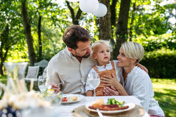 Potrait of young family during grill garden party.