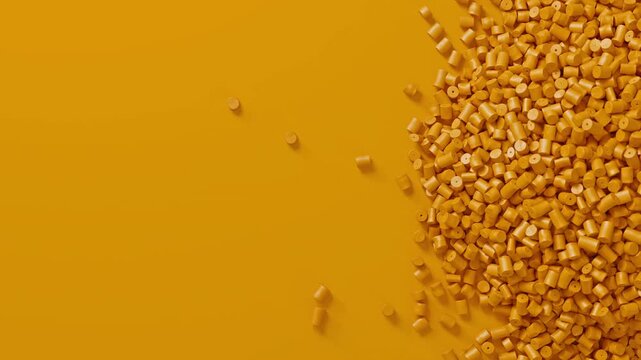 Closeup top view on yellow plastic polypropylene granules heap rotating on yellow backdrop, masterbatch polymer grain pile. HDPE or PVC resin pellets.