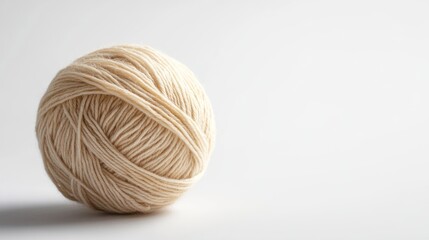 Beige yarn ball, single object on white backdrop, suitable for crafts
