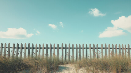 Obraz premium Wooden Fence along Sandy Dunes under Clear Blue Sky