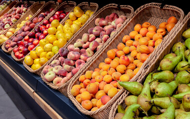 Fruits in wicker baskets are neatly arranged on the counter